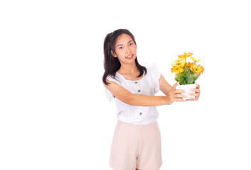 An Asian girl in white tank top and baige trunk holds yellow plastic flowers in her hands.