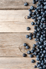 Overhead shot of tasty blueberries on wooden background with copyspace. Top view