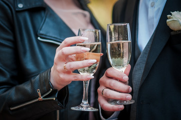 bride and groom clink glasses with champagne