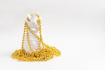 white pineapple in gold Christmas beads. alternative Christmas tree. minimal creative concept. 