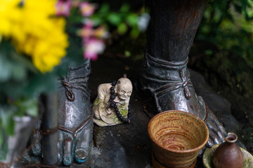 Buddhist statue and flowers 2