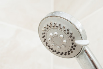 Diffuser in the shower closeup on a marble wall background.