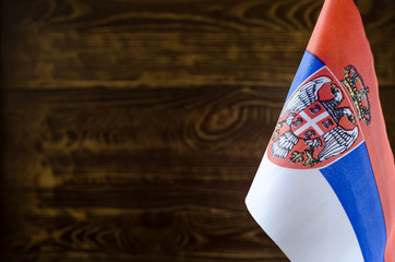 Fragment of the Serbian flag in the foreground space for text blurred background