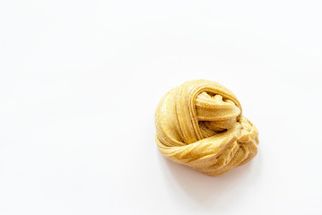 child plays with a slime. gold glitter slime. 