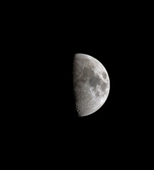 Half moon seen with an astronomical telescope, with enhanced colour to show the real colours of terrain surface.