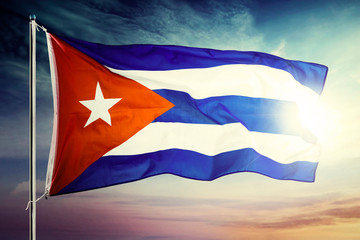 Cuba country flag fluttering with sunrise background