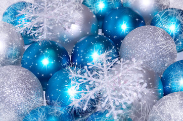 Christmas and New Year background. blue and silver sparkling balls, snowflake ornaments with snow