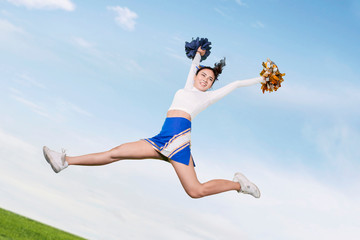 Low angle view of cheerleader performs in the park