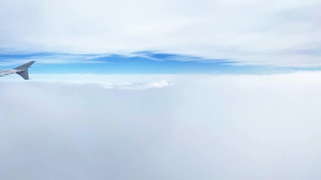 Wing of airplane above the clouds