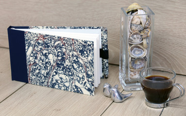 notebook on wooden  table with pen and coffee