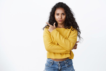 Picky sulking, disappointed african-american girl with curly hair, wear jeans, yellow sweater,...