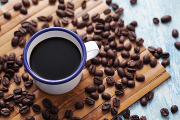 Coffee in cup and coffee bean on rustic table with a blank space for a text, Espresso in cup on blue background