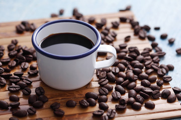 Coffee in cup and coffee bean on rustic table with a blank space for a text, Espresso in cup on blue background