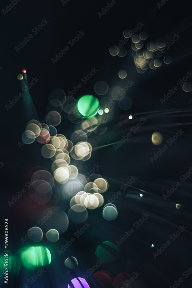 Poster beautiful abstract fiber optical network cable on a multi colored glow background.