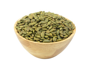 Pumpkin seeds in wooden bowl isolated on white