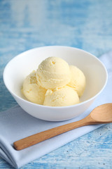 vanilla ice cream on a blue background with a blank space for a text, vanilla ice cream in white ceramic cup