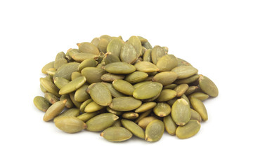 Heap of pumpkin seeds isolated on white close up