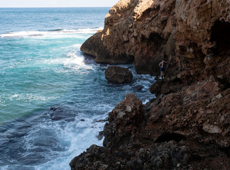 Rocky beach with caves and turquoise sea