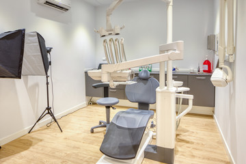 Fully equipped modern dental clinic box, with white walls and wooden flooring