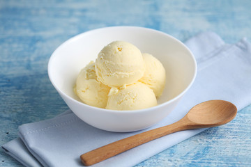 vanilla ice cream on a blue background with a blank space for a text, vanilla ice cream in white ceramic cup