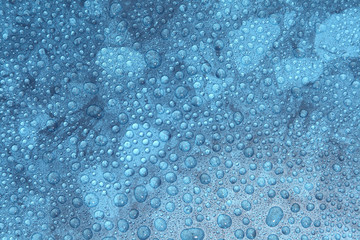 Fototapeta premium Close up water drops on blue background, Water drop in macro photography