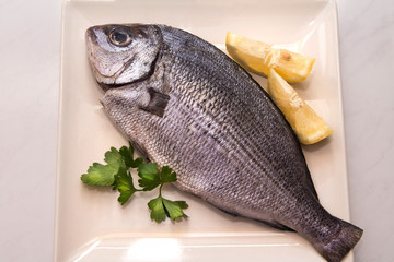 fresh fish with lemon and parsley