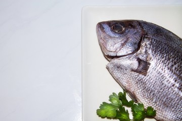 fresh fish on the plate closeup view