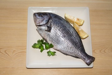 fresh fish with lemon and parsley