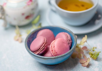 pink macaroons on a blue plate