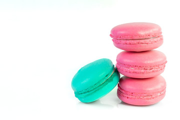 White background of colorful macaroons and copy space.