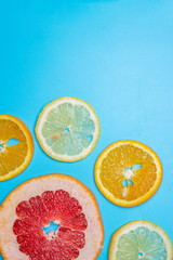 bright slices of oranges and grapefruit on a blue background