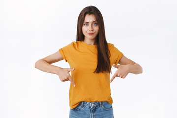 Skeptical, displeased attractive moody girlfriend pointing down with demanding, concerned and...