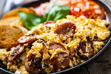 Breakfast - scrambled eggs with sausage and toasts
