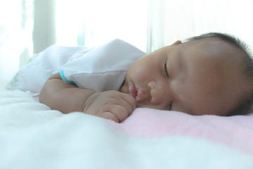 The baby's face is sleeping on a gentle bed, adequate sleep is the brain food. Allowing the body to rest Good mood, fresh and clear Create immunity