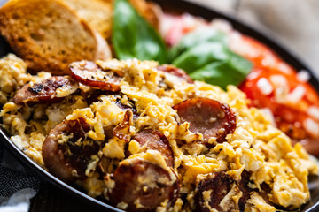 Breakfast - scrambled eggs with sausage and toasts