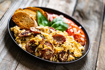 Breakfast - scrambled eggs with sausage and toasts