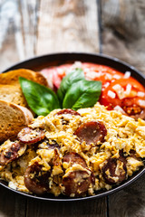 Breakfast - scrambled eggs with sausage and toasts