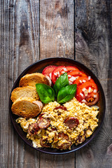 Breakfast - scrambled eggs with sausage and toasts