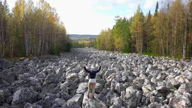 Young Female Tourist Hiking in Taganay National Park in Russia in Autumn. Aerial View of "Big Stone River", Biggest Deposit Occurrence of Aventurine Quartz
