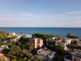 Fototapeta na wymiar Top view of a coastal town with a beach and beach umbrellas. Terracina, Province of Latina, Lazio Region, Italy
