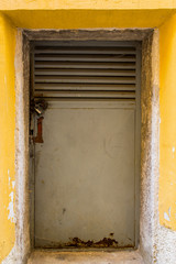 Rusty iron doors with ventilation and lock