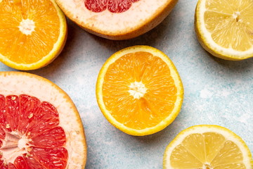 Fototapeta na wymiar bright slices of oranges and grapefruit on a blue background
