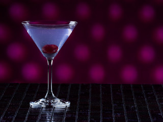 Aviation cocktail on pink dotted background, copy space on the right side