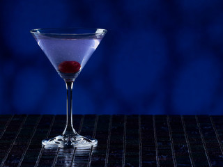Aviation cocktail on blue background, copy space on the right side