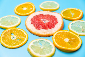 bright slices of oranges and grapefruit on a blue background
