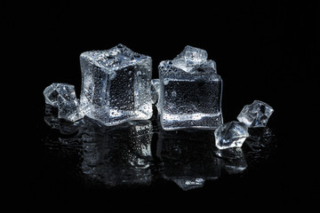 ice cubes on black isolated glass background