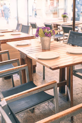 table with tablecloth and dishes from a restaurant on the street
