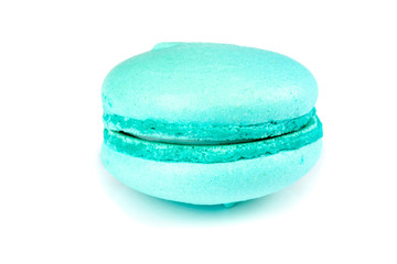 Azure blue macaroon coockie isolatd laying on a table.