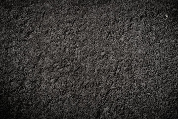 Texture of volcanic dark stone with rough surface
