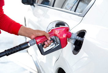 A white car refueling at a gas station